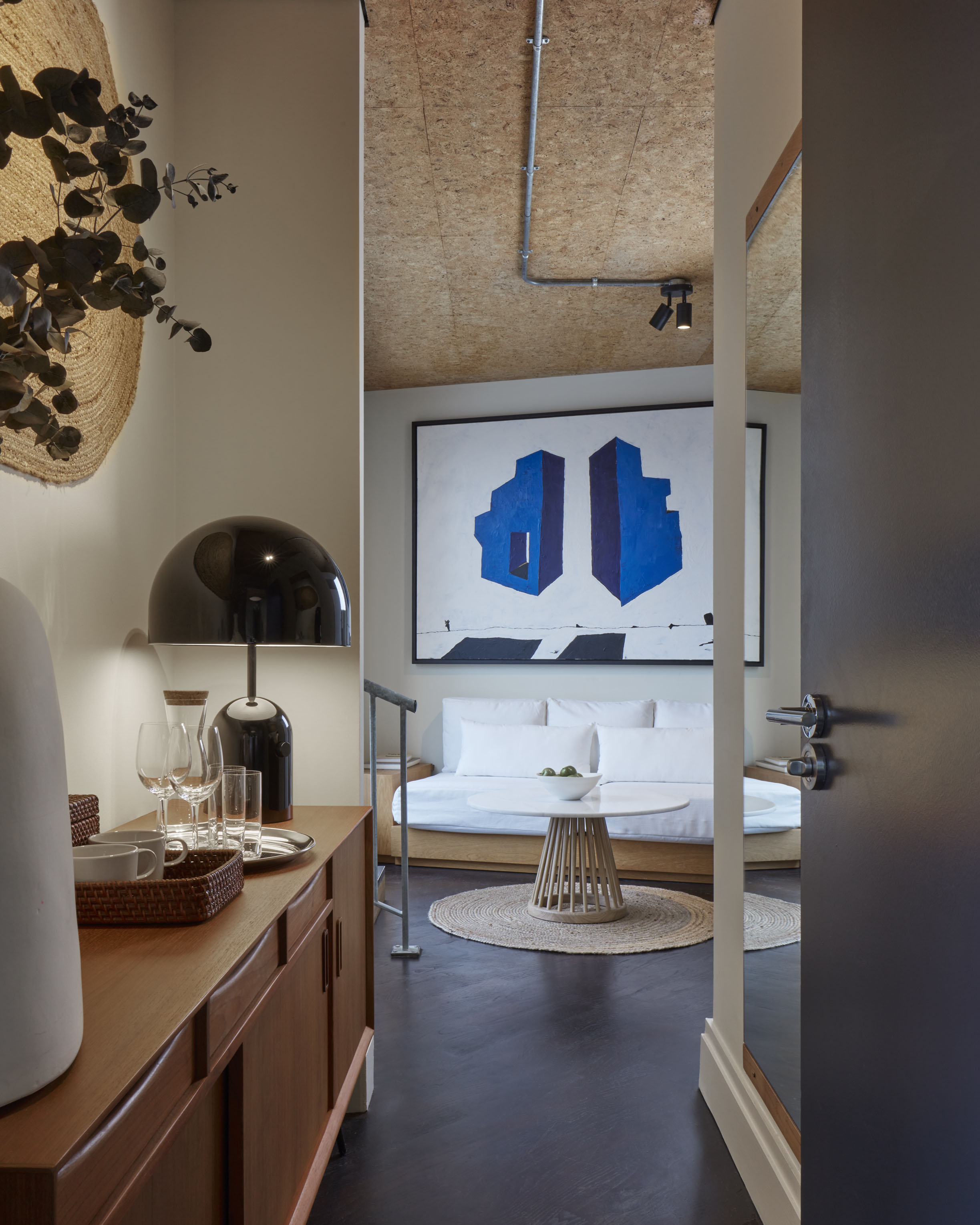 A modern and stylish bedroom featuring a comfortable bed, chic decor, and ambient lighting for a cosy atmosphere.