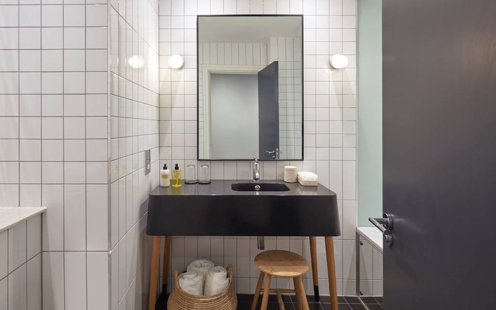 A stylish bathroom featuring a classic black and white tile floor, creating a timeless and elegant atmosphere.