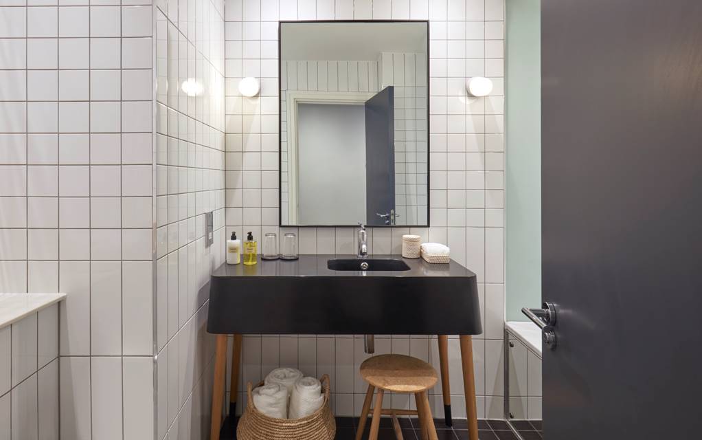 A stylish bathroom featuring a classic black and white tile floor, creating a timeless and elegant atmosphere.